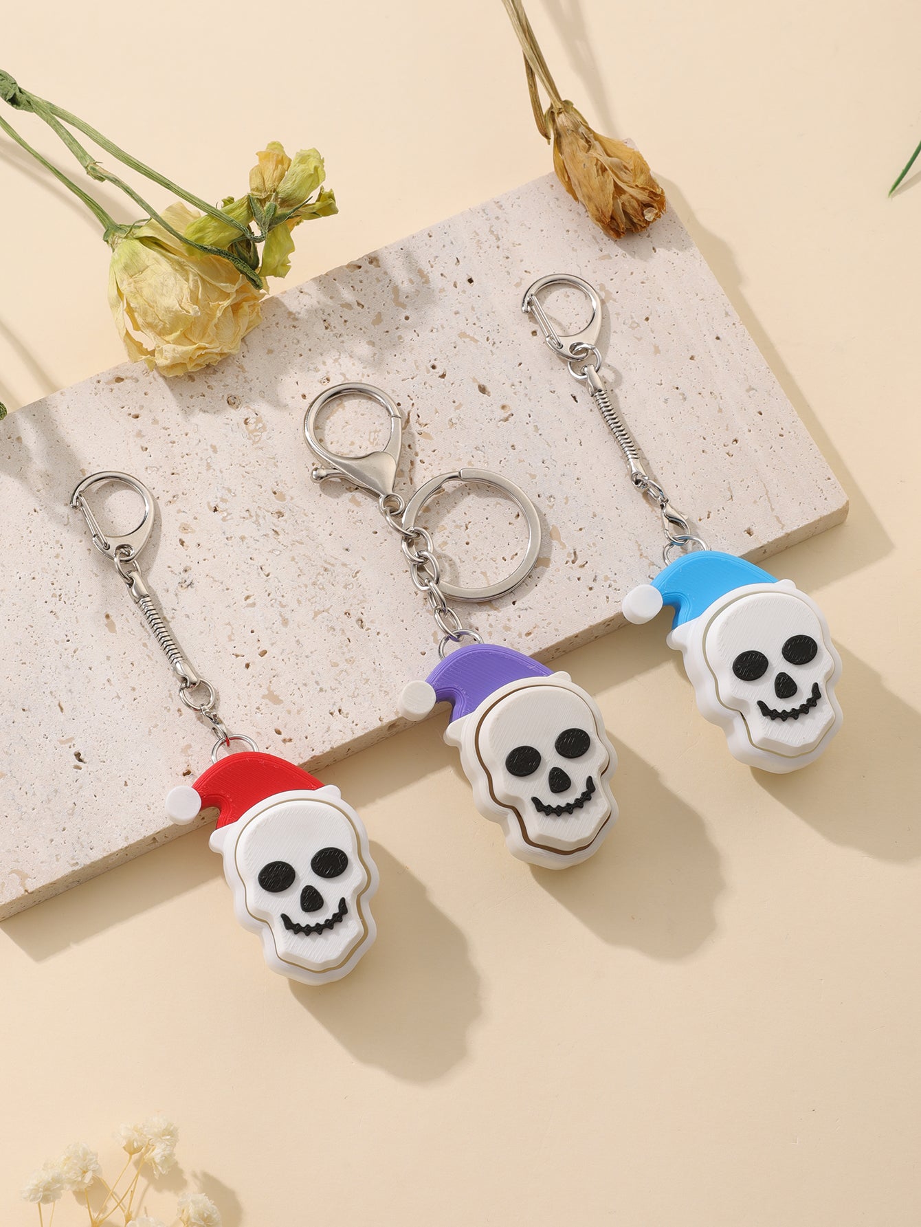 3D printed Christmas hat skull keychain - adult stress relief toy, with a portable anxiety relief gadget featuring a clickable keyboard design