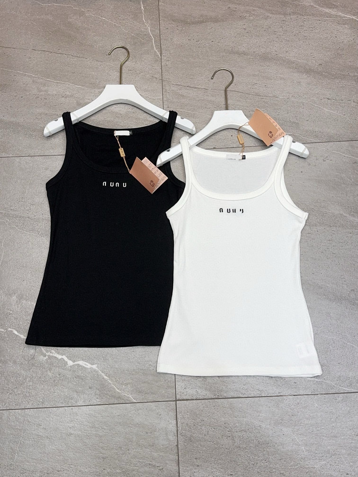 Designer brand M*&#039;s new knitted ribbed vest with a front logo, available in black and white.