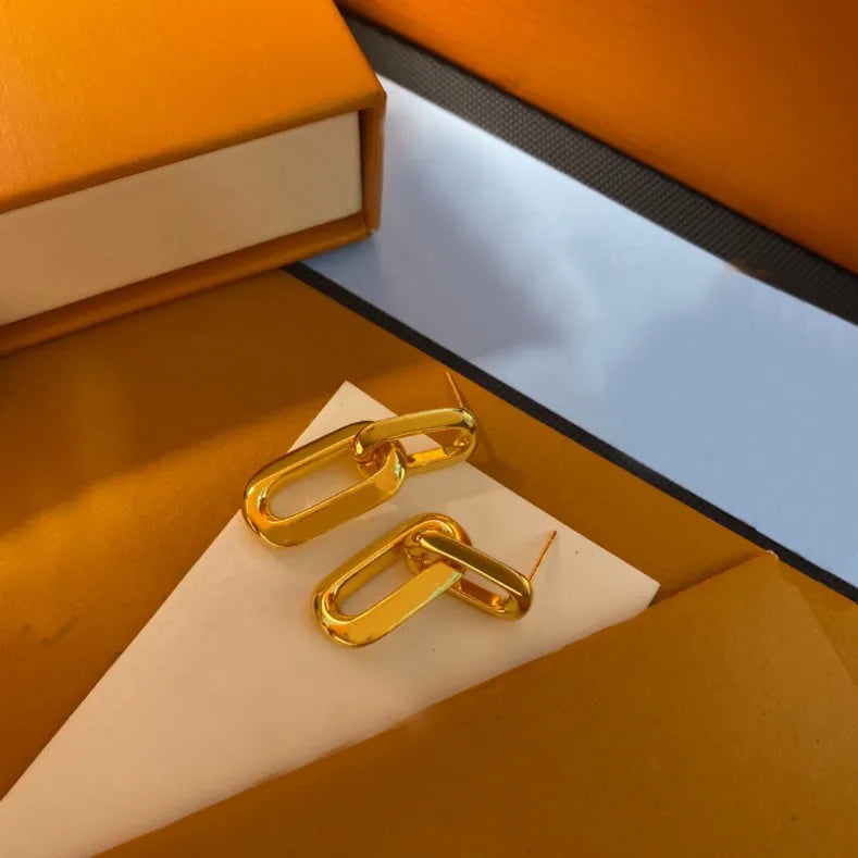 Golden Interlocking Hoop Earrings With Sleek Mirror Finish Elegant Geometric Jewelry And Stylish Gift For Her Modern Minimalist Design