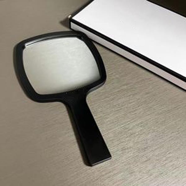 Designer holding makeup mirror black and white classic style mirror women&#039;s travel portable small mirror essential makeup mirror in bag