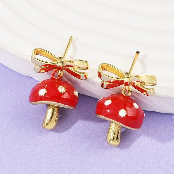 Boucles d'oreilles pendantes en laiton émaillé avec champignon et nœud papillon