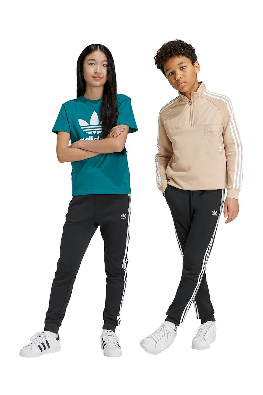 Otroški spodnji del trenirke adidas Originals TREFOIL PANTS črna barva, IY7484