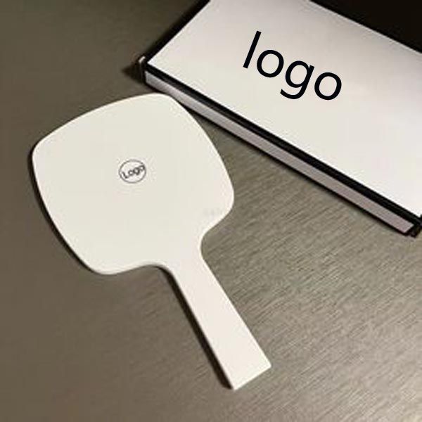 Designer holding black and white classic women&#039;s travel portable small essential makeup mirror in bag