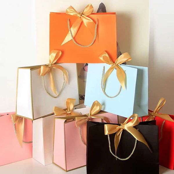 10 pieces-batch of new high-quality beautiful pink gift bags gift boxes decorative pajamas books black handles with ribbons paper bags cowhi