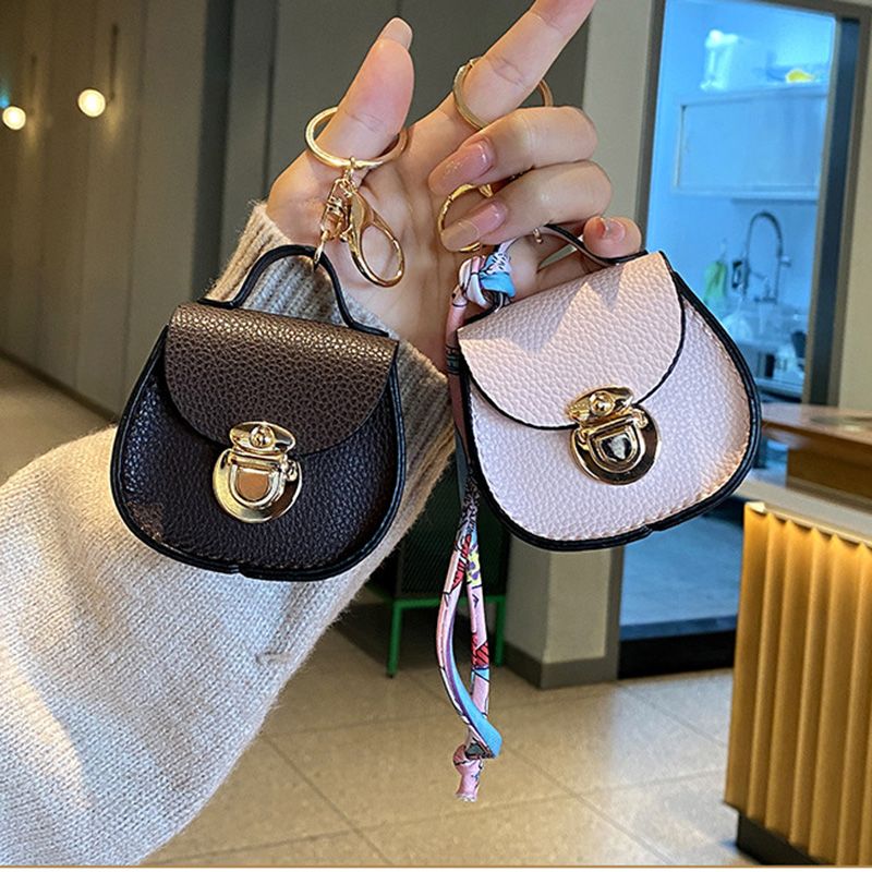 Luxury Designer Mini Saddle Headphone Bag Key Chain Bags Universal Headset Can hold other small items with keychain Storage Bags