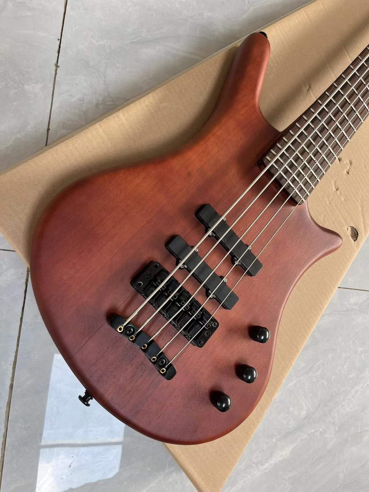 Sleek Modern Bass Guitar: Warm Brown Wood Grain Finish, 3 Black Pickups & Metallic Bridge