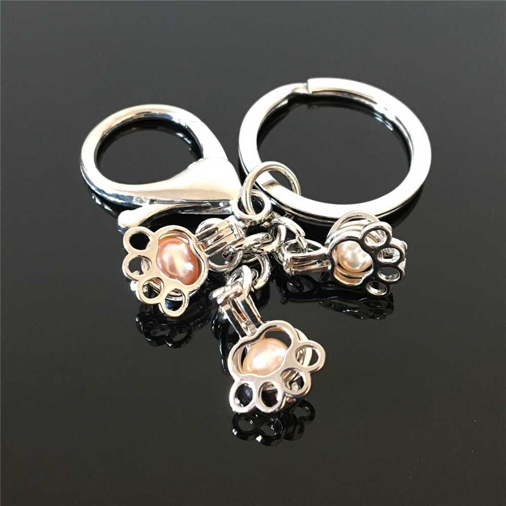 Euro-American paw print pearl cage key ring can open hollow noctilucent volcanic stone pendant keyring