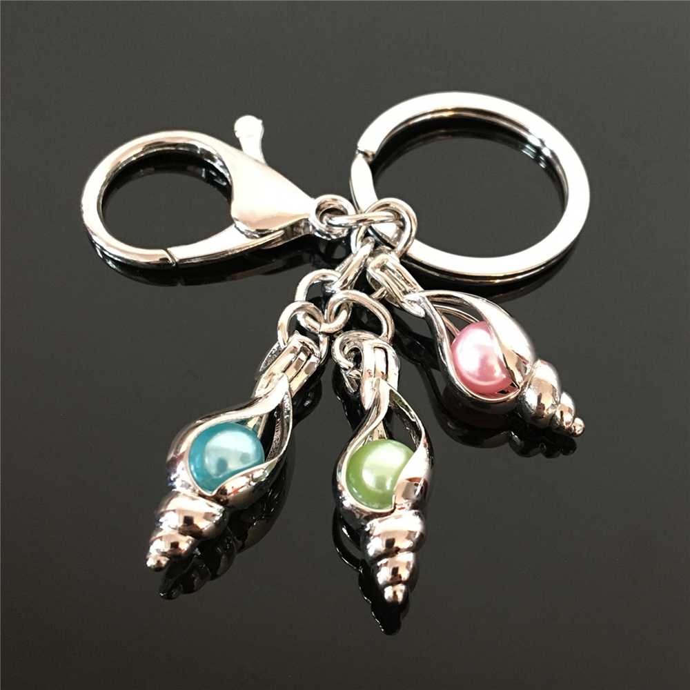 Pearl cage key ring in Europe and America can open keyring with hollow noctilucent volcanic stone pendant