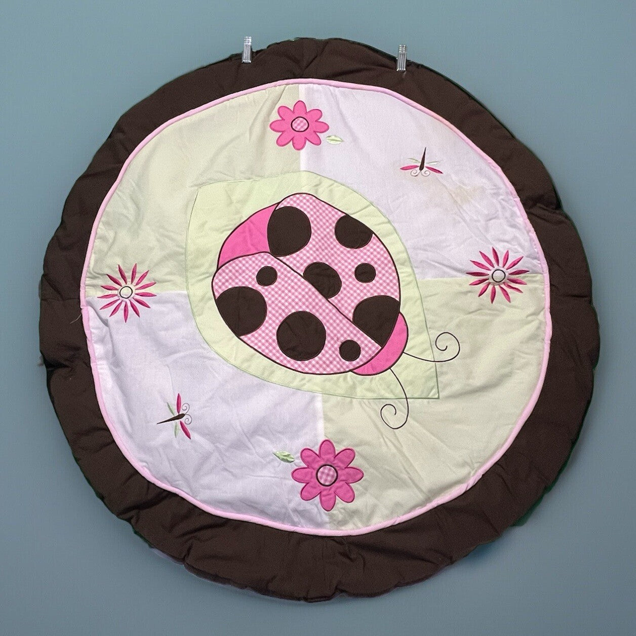 Infant play pad with rings on the back side
